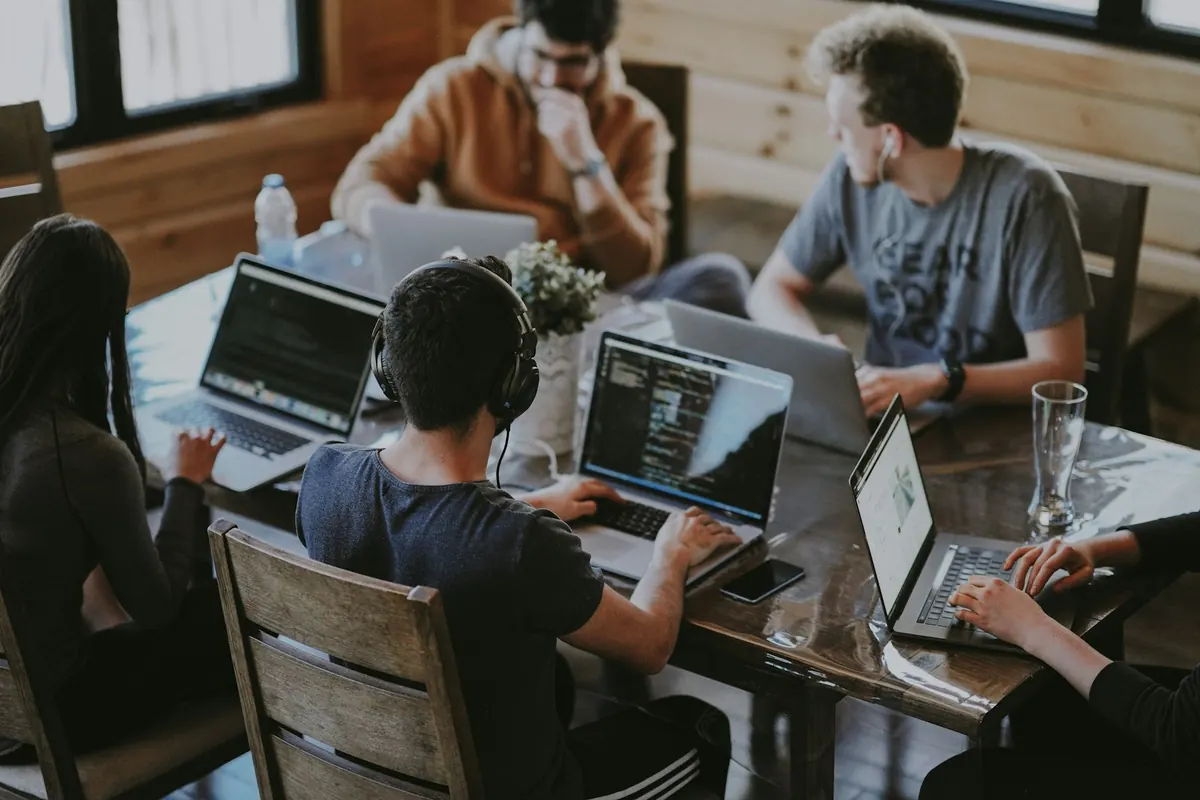 A group gathered around a laptop