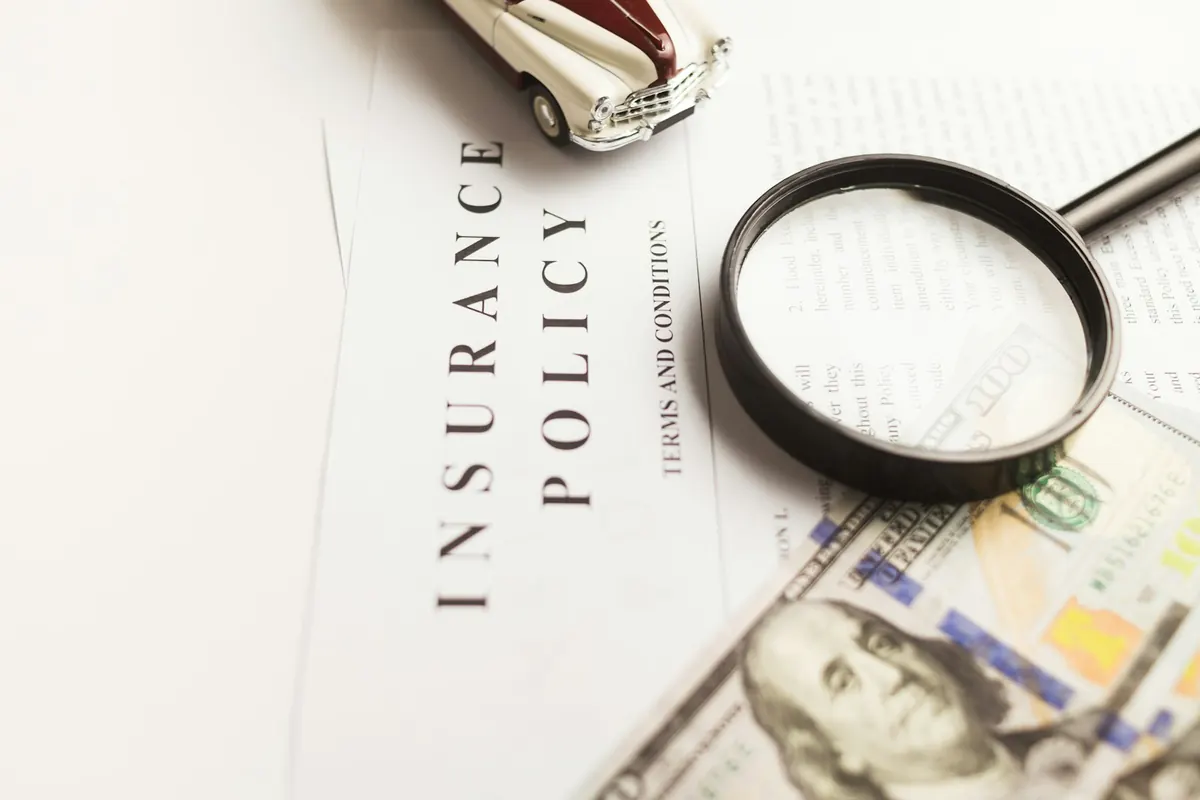 A magnifying glass over an insurance policy document