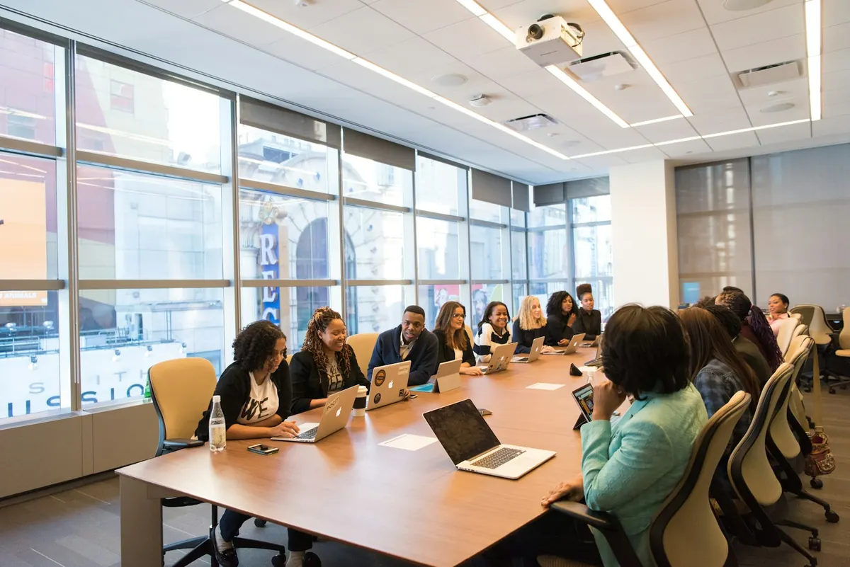 Colleagues working side by side at a wooden table